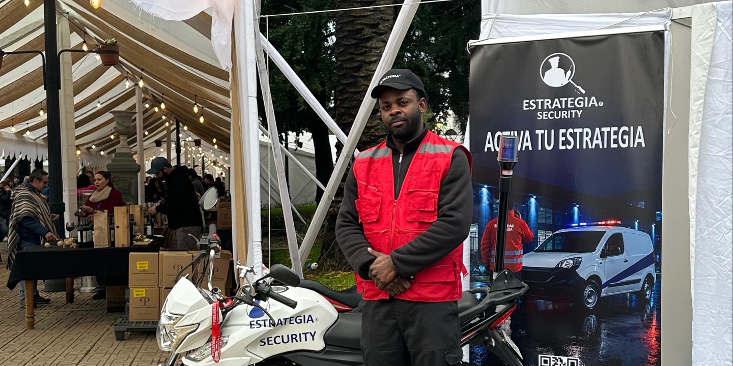 Guardia de Estrategia Security junto a la moto de patrullaje en el acceso de la Fiesta Costumbrista del Chancho de Talca 2026